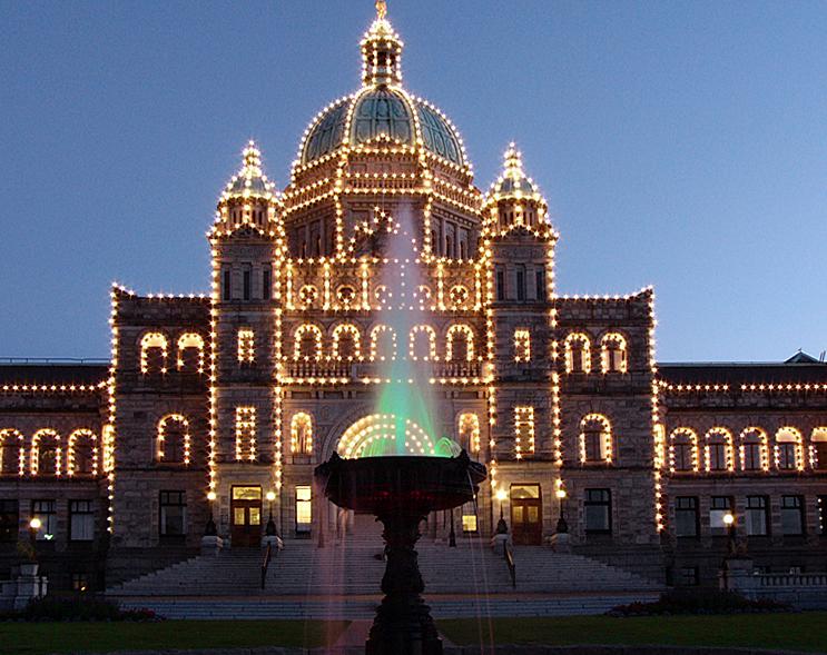 Provincial Legislature Building at night, with fountain.